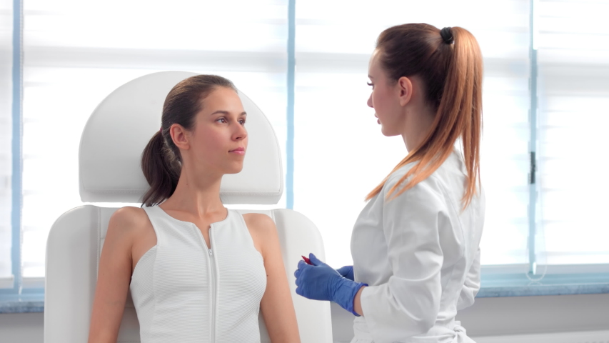 Female patient during the preparation for cosmetology procedure | Beautician marking up face, drawing the correction lines before the plastic surgery, injecting fillers or botulinum toxin injection. | Shutterstock HD Video #1051124218