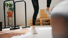 Young female fitness instructor coach adapts to lockdown of business and live stream workout routine on camera. Internet health and sport subscription, stay active while work from home