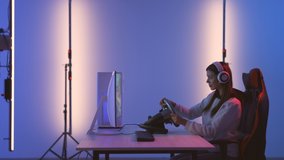 The beautiful woman playing video games in the blue light studio