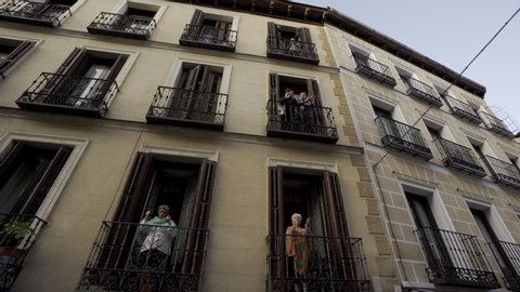 MADRID, SPAIN - APRIL 8TH 2020. Neighbors of Madrid central district applaud from their balconies to thank medical workers who are fighting coronavirus