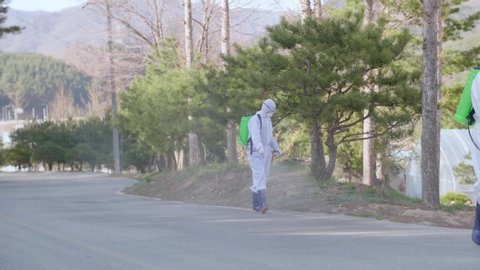 South Korea, April 13, 2020, Covid-19 pandemic, workers in protective suits disinfected the road, empty streets