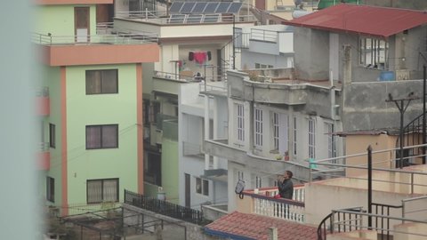 Kathmandu, Nepal - 25 November 2019: Nepalese man shaving on the balcony. Kathmandu, Nepal. House terrace.