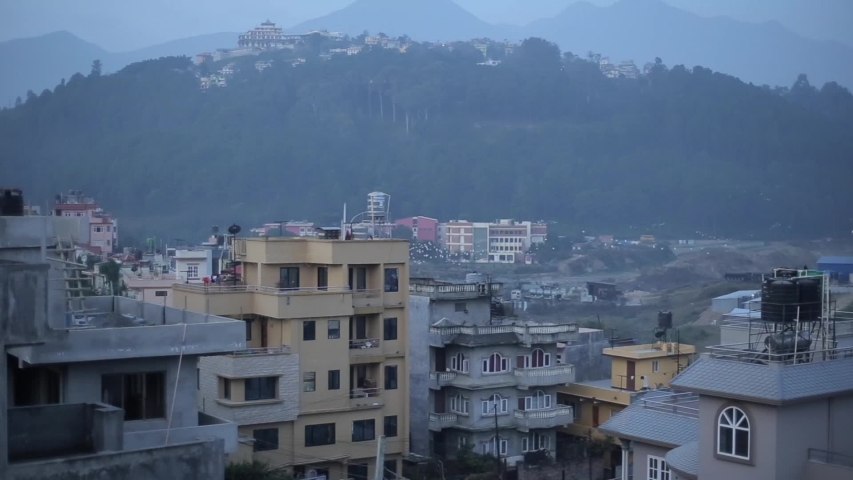 Houses of Kathmandu, Nepal. Mountains, birds flying.