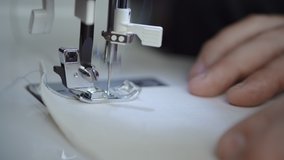 Side angle of beginner sewer practicing sewing straight lines with new sewing machine for a stay at home activity  - Powered by Shutterstock - Get 15% off with code: PIKWIZARD15