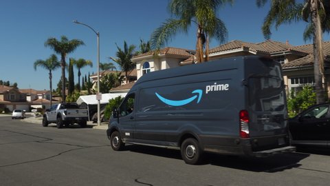 Amazon Prime delivery van out on deliveries in suburban neighborhood. Video taken in Vista, CA / USA - April 25, 2020.
