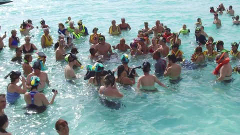 Cayman Islands - 12/01/2019: Group bathing of people in the Caribbean Sea near Grand Cayman Island.