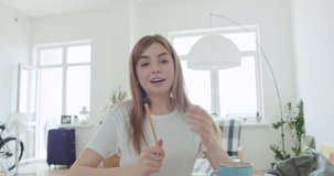 Smiling young woman blogger vlogger influencer working at home. Girl speaking looking at camera talking making videochat or conference call, Female record blog vlog, 4k webcam view slow motion