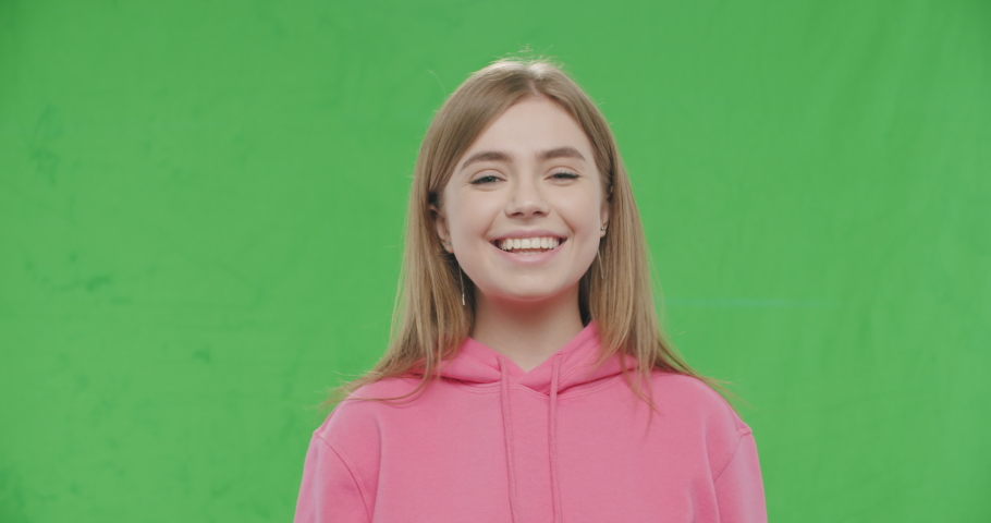 Happy smiling young pretty woman Isolated on Green Screen, Chroma Key. 4k raw video footage slow motion 60 fps
