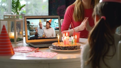 Happy Grandpa and Grandma Congratulate their Grandchildren Happy Birthday Using Laptop Video Call. Social distancing, self isolation during quarantine