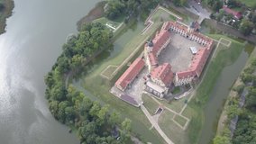 Beautiful Nesvizh castle from a bird's eye, which is located in the old town of Nesvizh, Belarus. A masterpiece of architecture and landscape art. Top view of a historic castle shot on a sunny day.