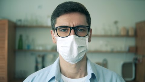 Face of a man in glasses and a protection mask in a close up. Portrait.