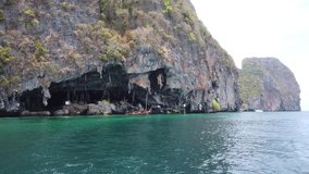Boat sails from cave near Phi Phi islands, Thailand.