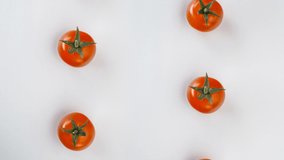 Red juicy tomatoes on white background stop motion animation 4k studio