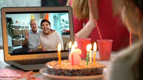 Happy Grandpa and Grandma Congratulate their Grandchildren Happy Birthday Using Laptop Video Call. Social distancing, self isolation during quarantine. Slow motion