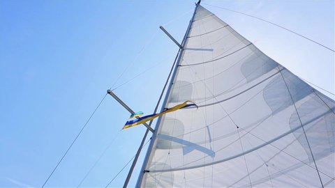 sails on a yacht filled with wind, the sun peeks behind the sails of a yacht, sea voyage on a yacht,  rope,  sailing yacht