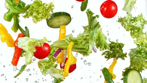 Super Slow Motion Shot of Flying Fresh Vegetables Isolated on White Background at 1000fps.