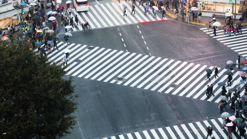 Thousands of people walk across the famous Shibuya Crossing in Tokyo Japan
