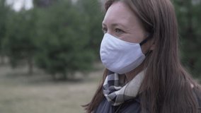 Young woman takes off medical mask and takes a deep breath in the woods - Powered by Shutterstock - Get 15% off with code: PIKWIZARD15