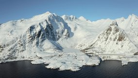 4k drone forward video (Ultra High Definition) of frozen Vassdalsvatnet lake from flying drone. Aerial winter seascape of Norwegian sea, Lofoten Islands archipelago. Life over polar circle.