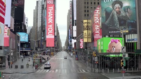 NEW YORK - APR 25, 2020: Times Square street empty with one car on road during coronavirus COVID-19 pandemic quarantine lockdown in Midtown Manhattan New York City NYC. 