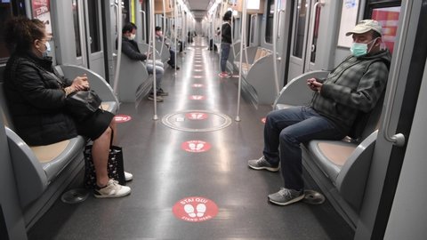 Milan, Italy - April 27, 2020: Social distancing signpostings on the metro trains advising passengers to maintain distance for travel on public transport to contain the Covid-19 coronavirus outbreak