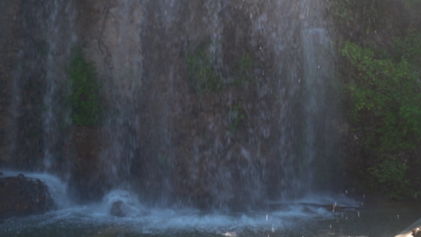Tilt Up shot of tourists standing on top of fountain in city, slow motion of people against sky - Tivoli, Italy