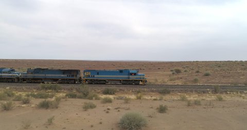 Aerial view of railroad transportation at desert against sky, drone moving over landscape - Swakopmund, Namibia
