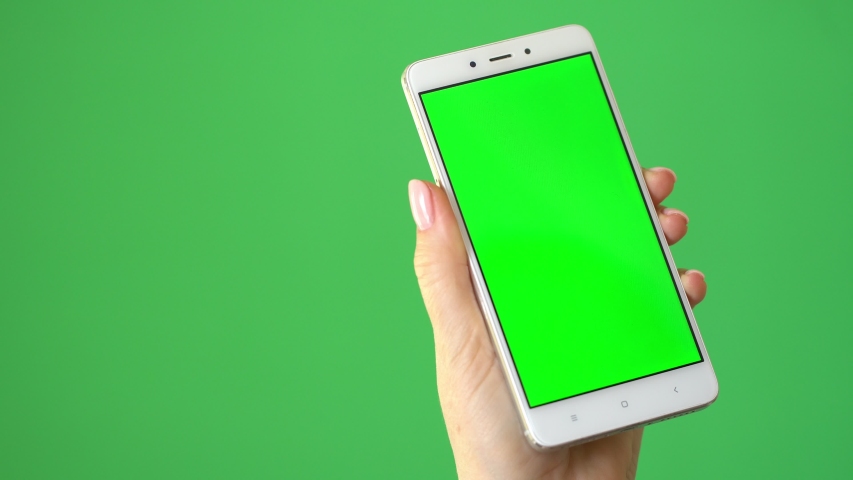 hand holding mobile phone on white background with green screen ...