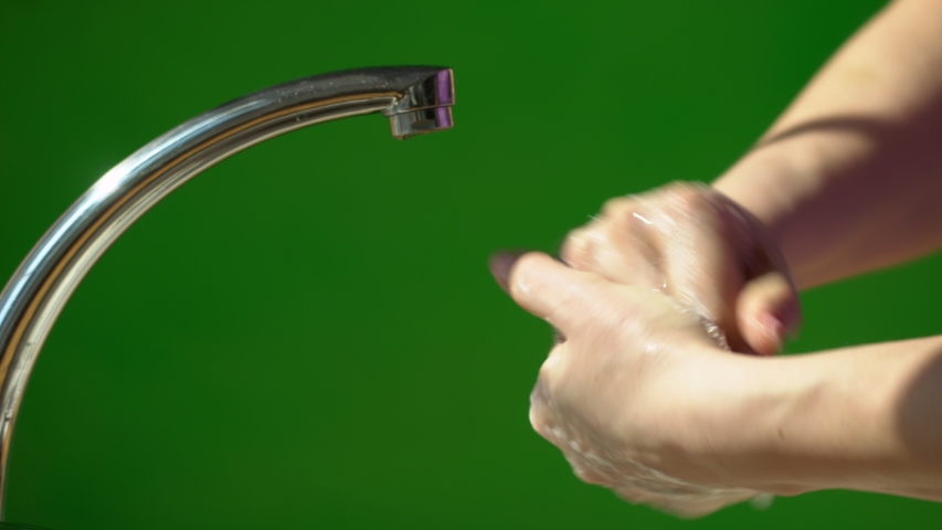 Coronavirus pandemic prevention wash hands with soap warm water rubbing fingers washing frequently or using hand sanitizer gel. Green background. Chroma key | Shutterstock HD Video #1051315315