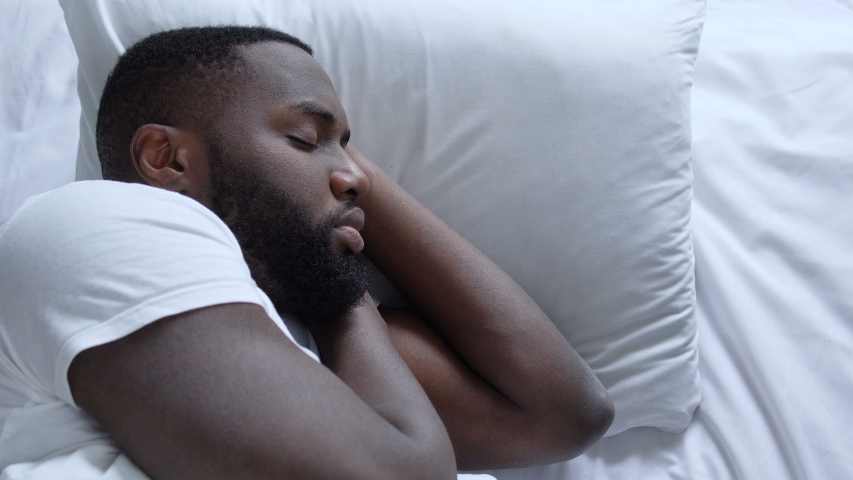 Lonely african american man lying in bed, dreaming about relationships, break-up | Shutterstock HD Video #1051327390