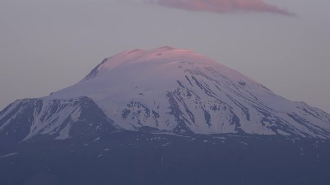 Mount Kilimanjaro transition night to day. Kibo, Mawenzi, and Shira, is a dormant volcano in Tanzania. Time lapse nature high altitude snow snowy geology of the interior of the volcanic edifice effect