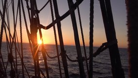 Sunset through the shrouds and rigging of an old sailing ship. Seascape slow motion video. - Powered by Shutterstock - Get 15% off with code: PIKWIZARD15