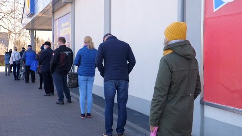 Coronavirus Pandemic Concept. Long Queue To Enter The Supermarket For Grocery Shopping. Bialystok, Poland - March 2020.