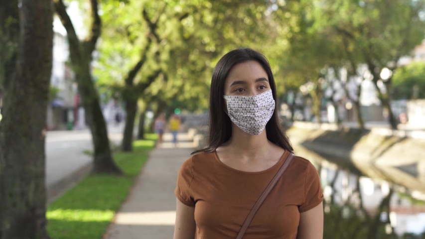 woman wearing mask sanitize hands walking on the street. pandemic coronavirus concept
 Royalty-Free Stock Footage #1051345900