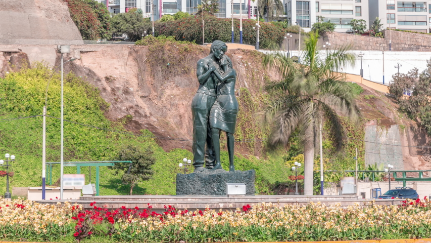 Statues in Chorrillos park timelapse view from the beach in Lima, Peru. Traffic on Circuito de Playas road near waterfront. Green lawn on a background