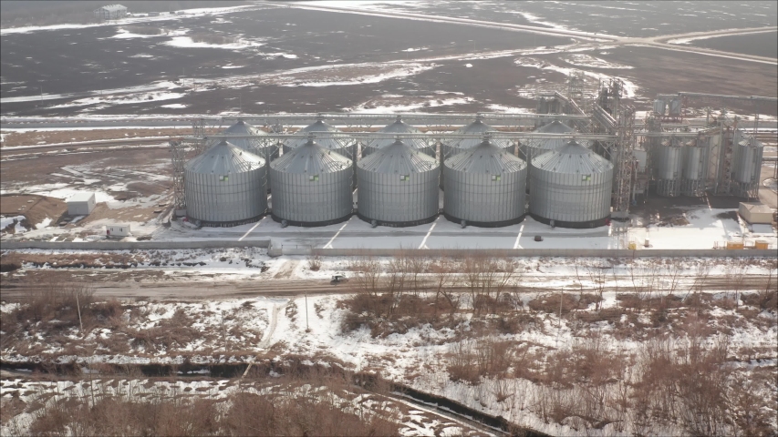 Aerial close to huge steel structure grain elevator warehouse, grain ...