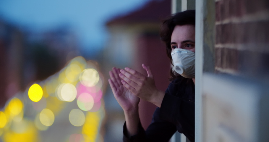 Quarantine , the coronavirus pandemic. Clapping hands. People applaud health workers. Girl takes part in a flash mob. Quarantine ending. Celebration. A close up of a person. Italy | Shutterstock HD Video #1051356295
