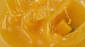 Mango chunks falling into mango juice in slow motion. . - Powered by Shutterstock - Get 15% off with code: PIKWIZARD15