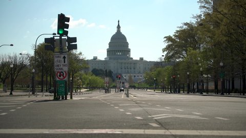 View from middle of empty streets near US Capitol mid day showing bike lanes.