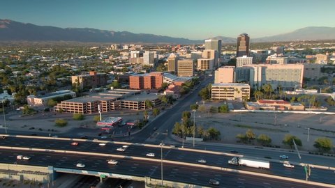 Tucson, Arizona, USA. 29 April 2020: Aerial flying over freeway & downtown Tucson at sunset. 