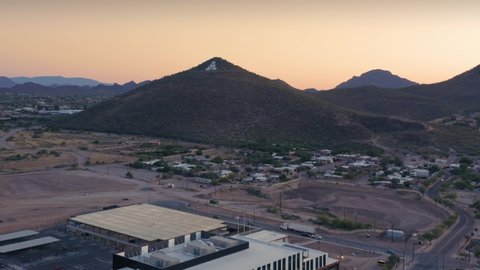 Tucson, Arizona, USA. Aerial flying over suburbs towards Sentinel Peak Park, also known as A mountain. Tucson at sunset. 