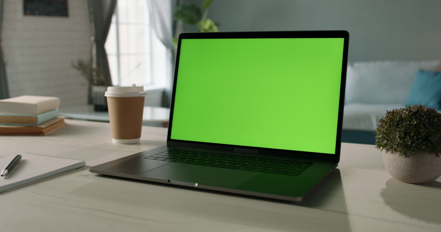 The table of distant worker at home. Modern laptop computer with chroma key green screen. Remote work, distance learning, technology concept close up 4k video template Royalty-Free Stock Footage #1051390204