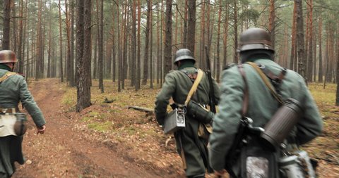 Moscow, Russia- December 21, 2019: Historical Re-enactment. Re-enactors German Wehrmacht Infantry Soldier In World War II Marching Walking Along Forest Road In Autumn Day. Group of Soldiers In Forest