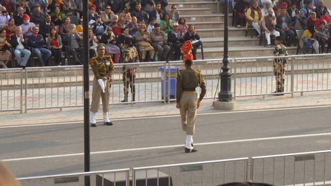 Indian Border Security Soldier in Khaki Uniform and Red Hat Marching at the Wagah Flag Lowering Ceremony of the Pakistan-India Border - Attari, Punjab, India - March 2019