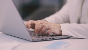 Arab businessman works on laptop, writes text on the keyboard. Close-up of hands. - Powered by Shutterstock - Get 15% off with code: PIKWIZARD15