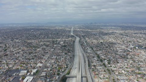 AERIAL: Spectacular View over Endless City Los Angeles, California with Big Highway Connecting to Downtown on Cloudy Overcast Day 