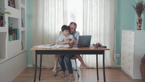 Parent working online from home. Remote work. Family on self-isolation. Home office. Dad and son enjoy their time together playing computer. Happy childhood. Paternity. Quarantine. Epidemic. Crisis. - Powered by Shutterstock - Get 15% off with code: PIKWIZARD15