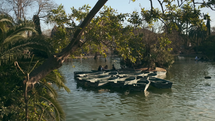 Amazing shot of beautiful lake with wood boats in city park on a sunny day