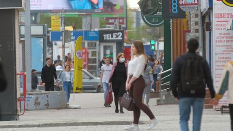 Russia, Novosibirsk - April 27, 2020: Real People Go Walk in Resperatory Mask. Pandemic Covid-19. Corona Virus Mers. Human Public City. Epidemic Coronavirus. Masked Face Woman. Corona virus Covid 19.