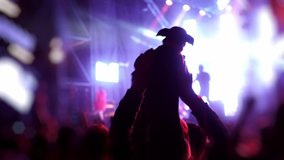 Dog at the concert. Dog musician, music lover. A fan holds the dog over his head. Dachshund dog sings a song. Happy fans watching a musical performance. The crowd jumps and claps its hands. - Powered by Shutterstock - Get 15% off with code: PIKWIZARD15